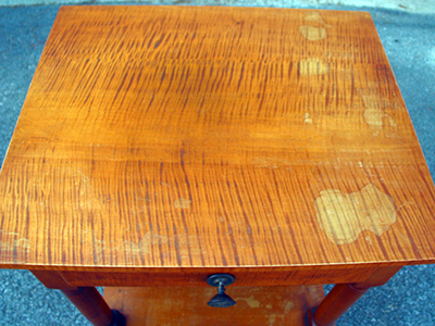Significant moisture damage destroyed the top finish.