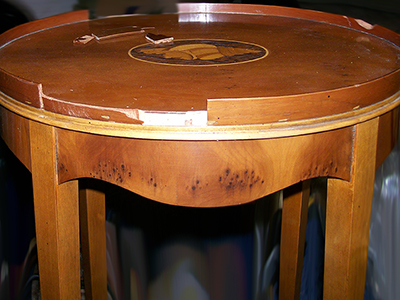 The edge banding of this table was severely damaged.